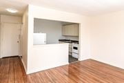 Hamilton apartment for rent - A kitchen with a white countertop and wooden floors.