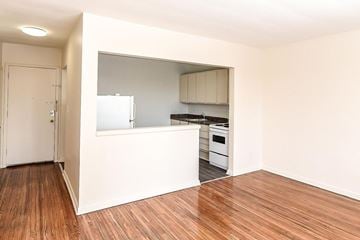 Hamilton apartment for rent - A kitchen with a white countertop and wooden floors.