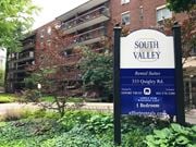 Hamilton apartment for rent - A sign for South Valley Apartments stands in front of a brick building.