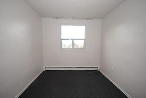 Hamilton apartment for rent - A room with a window and a carpeted floor.