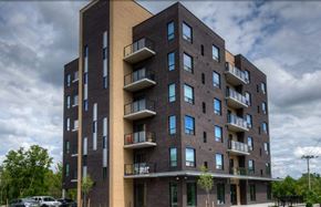 Kitchener apartment for rent - A modern apartment building with balconies and multiple windows.