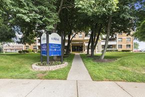 Hamilton apartment for rent - The Supreme sign is blue and white and is in front of a building.