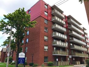 Hamilton apartment for rent - The building is made of red bricks and has a sign that says "The Beaumont".