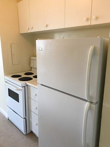 Hamilton apartment for rent - A white refrigerator and oven in a kitchen.