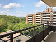 Hamilton apartment for rent - A balcony overlooks a parking lot and a wooded area.