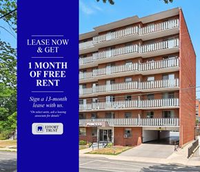 Hamilton apartment for rent - A large brick building with a sign offering a free month of rent.