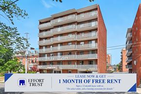Hamilton apartment for rent - A large building with a sign offering a free month of rent.