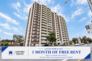Kitchener apartment for rent - A tall building with a sign offering 1 month of free rent.