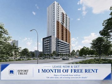 Kitchener apartment for rent - A large building with a sign in front of it advertising a free month of rent.