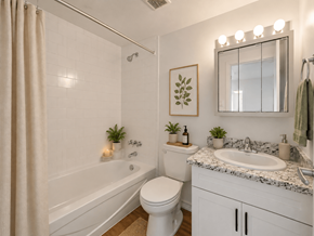 Hamilton apartment for rent - A white bathroom with a toilet, sink, and a shower.