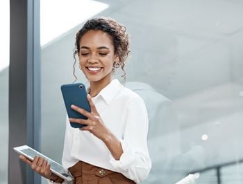 A woman is holding a tablet 