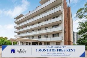 Hamilton apartment for rent - A tall apartment building with a sign offering a free month of rent.