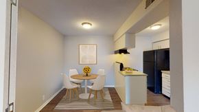 Independence apartment for rent - A kitchen with a refrigerator and a dining area.