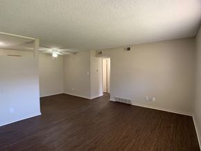 Kansas City apartment for rent - A room with wooden flooring and a door in the middle.
