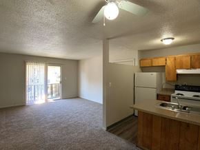 Kansas City apartment for rent - A kitchen area with a refrigerator, sink, and stove.