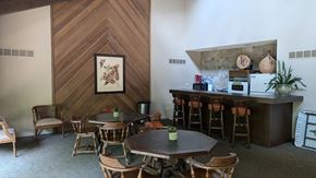 Kansas City apartment for rent - A dining room with a wooden table and chairs and a bar area.