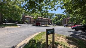 Kansas City apartment for rent - Parking lot for an apartment complex with a sign in front