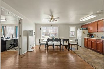 Kansas City apartment for rent - A kitchen with a dining table and chairs in the middle of the room.