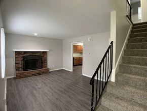 Independence apartment for rent - A living room with a fireplace and a staircase.