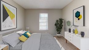 Independence apartment for rent - A bedroom with a bed, nightstand, and a dresser.