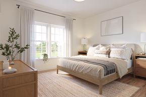 New Paltz apartment for rent - A bedroom with a large bed and a nightstand with a vase on it.