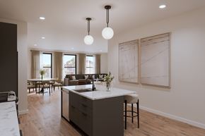 Beacon apartment for rent - A modern kitchen with a large island and pendant lights.