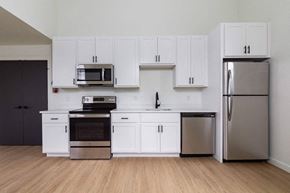 Poughkeepsie apartment for rent - A kitchen with white cabinets and stainless steel appliances.