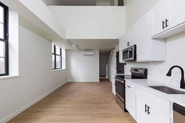 Poughkeepsie apartment for rent - A kitchen with white cabinets and a wooden floor.