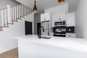 Poughkeepsie apartment for rent - A kitchen with a white countertop and black appliances.