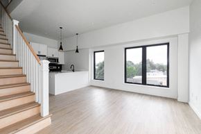 Poughkeepsie apartment for rent - A spacious living room with a staircase on the left side.