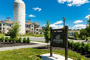 Poughkeepsie apartment for rent - A sign for Lagrange Farms stands in front of a building and a silo.