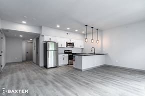 Poughkeepsie apartment for rent - A modern kitchen with stainless steel appliances and a bar area.