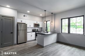 Poughkeepsie apartment for rent - A modern kitchen with a refrigerator, microwave, and oven.