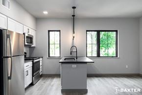Poughkeepsie apartment for rent - A modern kitchen with a large island and stainless steel appliances.