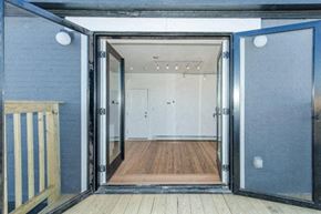 Beacon apartment for rent - A room with a wooden floor and white walls is visible through an open door.