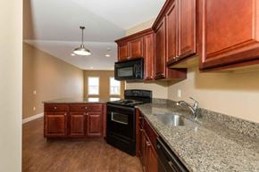 Poughkeepsie apartment for rent - A kitchen with brown cabinets and granite countertops.