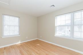 Poughkeepsie apartment for rent - A room with wooden floors and two windows.