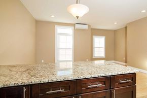 Poughkeepsie apartment for rent - A kitchen with granite countertops and wooden cabinets.
