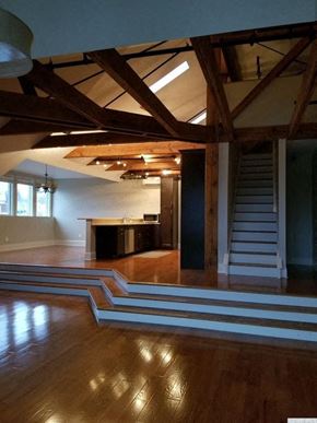 Catskill apartment for rent - A large open space with wooden floors and a staircase.