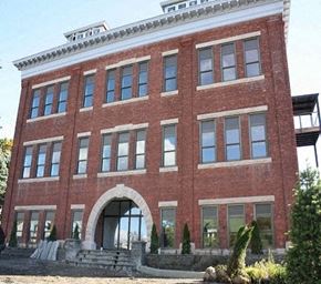 Catskill apartment for rent - A red brick building with a white trim around the windows and a white arched entrance.