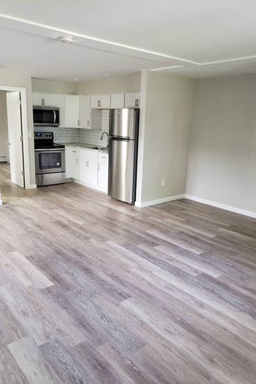 Poughkeepsie apartment for rent - A kitchen with a stove top oven and a refrigerator.