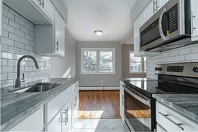 Poughkeepsie apartment for rent - A modern kitchen with a black stove top oven.