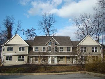 Poughkeepsie apartment for rent - A large, two-story house with a grey and white exterior.