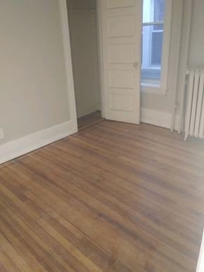 Poughkeepsie apartment for rent - A room with a wooden floor and a white door.