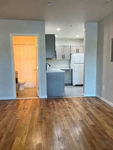 Poughkeepsie apartment for rent - A kitchen with a white refrigerator and wooden floors.