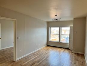 Poughkeepsie apartment for rent - A room with wooden floors and a ceiling fan.