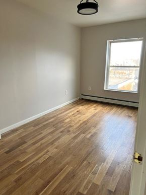 Poughkeepsie apartment for rent - A room with a window and wooden flooring.