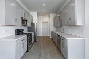 Poughkeepsie apartment for rent - A kitchen with white cabinets and appliances.