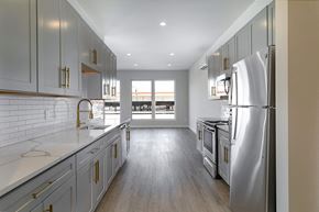 Poughkeepsie apartment for rent - A modern kitchen with a refrigerator on the right.