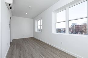 Poughkeepsie apartment for rent - A room with a window and a wall-mounted air conditioner.